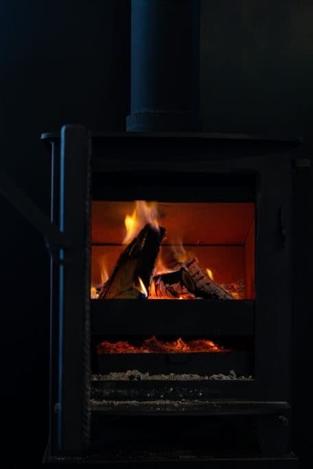 Logs burning in the black wood stove.